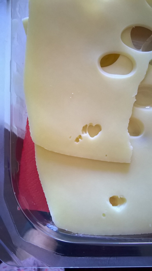 a heart in the slice of cheese
